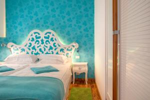 Ένα ή περισσότερα κρεβάτια σε δωμάτιο στο Piccolo Grand Hotel