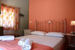 
a bedroom with a white bedspread and a blue comforter at Viva Elafonisi in Plokamianá
