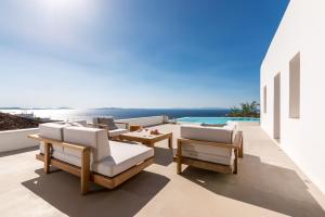 a patio with lounge chairs and a view of the ocean at Sotavento Villa in Fanari