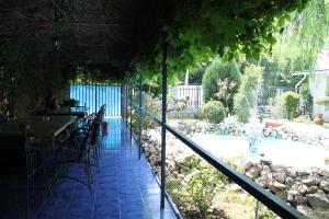 a patio with a table and chairs next to a pool at Hotel Vila Alex in Costinesti +26 photos