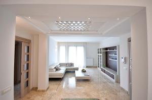 a living room with a couch and a tv at Villa Luigia Luxury Relais in Gallipoli