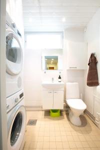 uma casa de banho com uma máquina de lavar roupa e um WC em Design Apartments Kristiina em Naantali