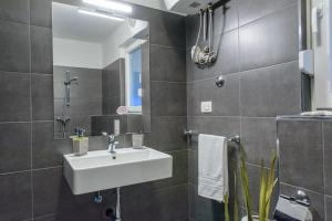 a bathroom with a sink and a mirror at TiaMar in Slatine +43 photos