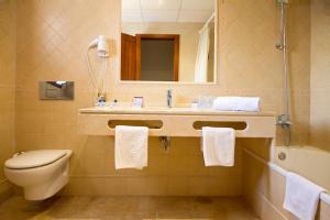 a bathroom with a toilet a sink and a bathtub at Hotel Antonio in Zahara de los Atunes