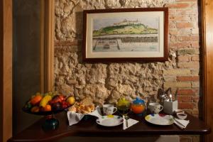 a table with a bowl of fruit and a plate of food at CampuSpace in Cagliari