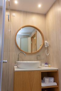 a bathroom with a sink and a mirror at Hotel Opal Exclusive Bihać in Bihać