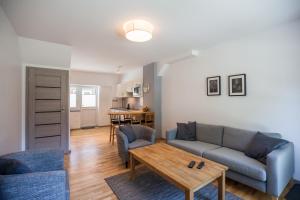 a living room with a couch and a table at Namelis Preiloje in Neringa
