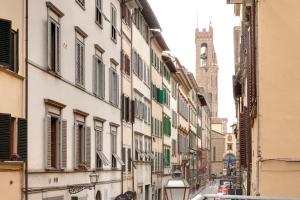 an alley with buildings and a church in the distance at Windows On Florence in Florence