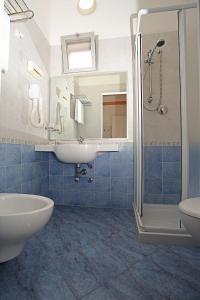 リミニにあるHotel Piccinelliのバスルーム(洗面台、トイレ、シャワー付)