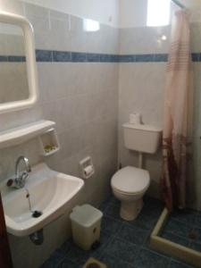 a bathroom with a white toilet and a sink at Magic View in Naxos Chora