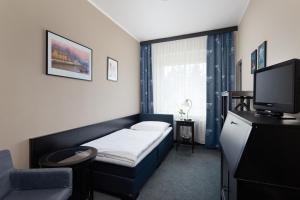 En eller flere senger på et rom på Hotel Tulipan Pruhonice