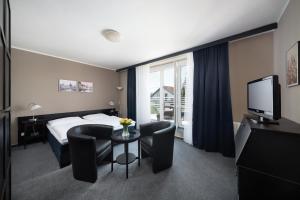 Televízia a/alebo spoločenská miestnosť v ubytovaní Hotel Tulipan Pruhonice