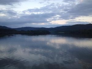 a body of water with mountains in the background at Shimaotoya in Iriomote