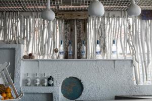a bunch of bottles on a shelf in a kitchen at Xenios Hotel in Pefkochori +40 photos