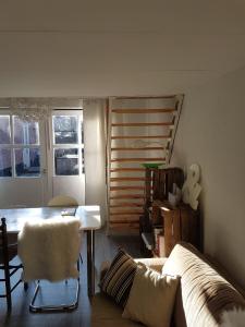 een woonkamer met een bank en een tafel bij Unieke stadswoning voor 2 personen met Finse sauna in Apeldoorn