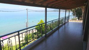 a balcony with a view of the beach at xanthi's sea front villas in Flámbouras