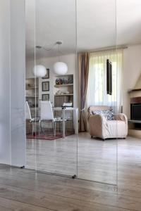 a living room with a large glass wall at Villa Vignolo in Stresa