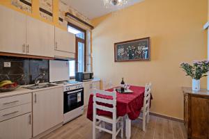 a kitchen with a table with a red table cloth at Casa Di Silvia in Rethymno Town