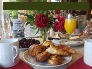 a table with a plate of croissants and pastries at Le Ranch des Lacs in Augne