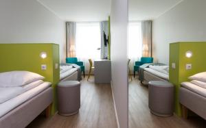 
a hotel room with two beds and two lamps at Thon Hotel Trondheim in Trondheim
