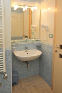 a bathroom with a sink and a mirror at Cala Dei Normanni - Camere sulle Mura in Otranto