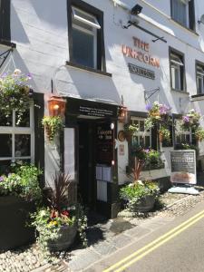 a restaurant with plants in front of a building at The Unicorn, Ambleside in Ambleside