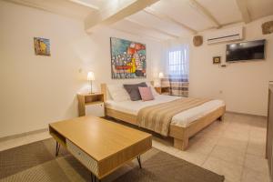 a bedroom with a bed and a table in it at Honey Art Apartment in Cres