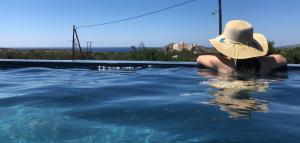 Una donna con un cappello seduta in piscina di Ariadne a Elafonisi Altre 20 foto