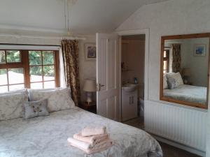 a bedroom with a bed with towels on it at Sea Lodge B&B in Durrus