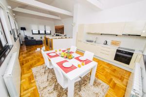 a white kitchen with a white table and chairs at LUXURY 3 story House- BEST VIEW in Sarajevo