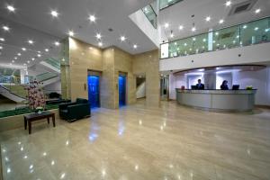 a lobby with a reception desk in a building at SV Business Hotel Diyarbakır in Diyarbakır