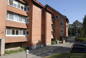 a brick building with a car parked next to it at Karolina in Nida