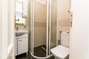 a bathroom with a shower and a toilet and a sink at Modern Apartment in the Heart of the City Center! in Sarajevo +18 photos
