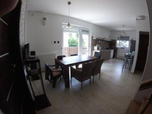 a kitchen and dining room with a table and chairs at Dózsaház in Zalaegerszeg