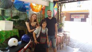 a family posing for a picture in a room at Adchara Mansion in Chiang Rai
