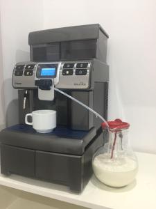 a coffee maker with a cup on a shelf at B&B a casa di PaPi in Lizzano