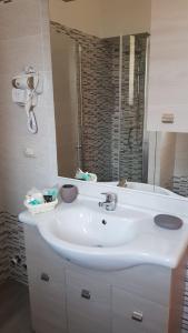 a bathroom with a white sink and a mirror at B&B a casa di PaPi in Lizzano +34 photos