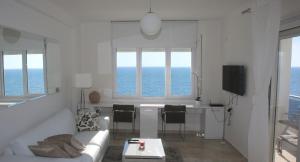 a living room with a couch and a table at White Residence Luxury Apartments in Sarandë