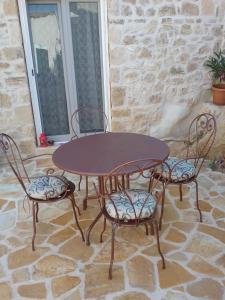 a wooden table and chairs on a patio at Villa Magda in Makrádes