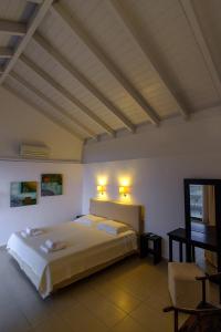 a bedroom with a large bed with lights on the ceiling at Gerakari Suites in Agia Pelagia +50 photos