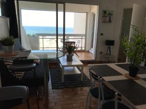 卡诺海滩Exceptionnel ! Appartement vue imprenable sur mer.的客厅配有桌子,享有海景 更多18张照片