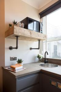 a kitchen counter with a sink and a window at One Broad Street in Brighton & Hove