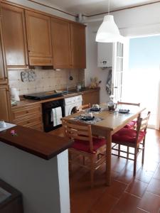 a kitchen with a wooden table with chairs and an oven at Piazzadarmi 26 in Ancona +12 photos