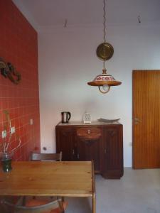 a dining room with a table and aendant light at One step from the beach, praia da Aguda in Arcozelo