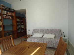 a room with a bed and a wooden table and a table sidx sidx at One step from the beach, praia da Aguda in Arcozelo