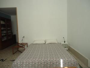a bedroom with a large bed in a room at One step from the beach, praia da Aguda in Arcozelo