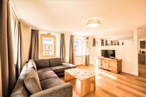 a living room with a couch and a table at Hotel Münsterhof in Müstair