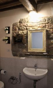a bathroom with a sink and a mirror on the wall at B&B Paradiso in Gubbio +41 photos