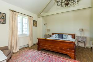 a bedroom with a bed and a couch and a window at The Delaval Rooms in Lincoln