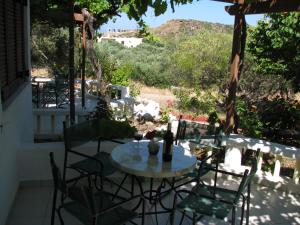 a table and chairs on a patio with a view at Sunrise Apartments in Palekastron